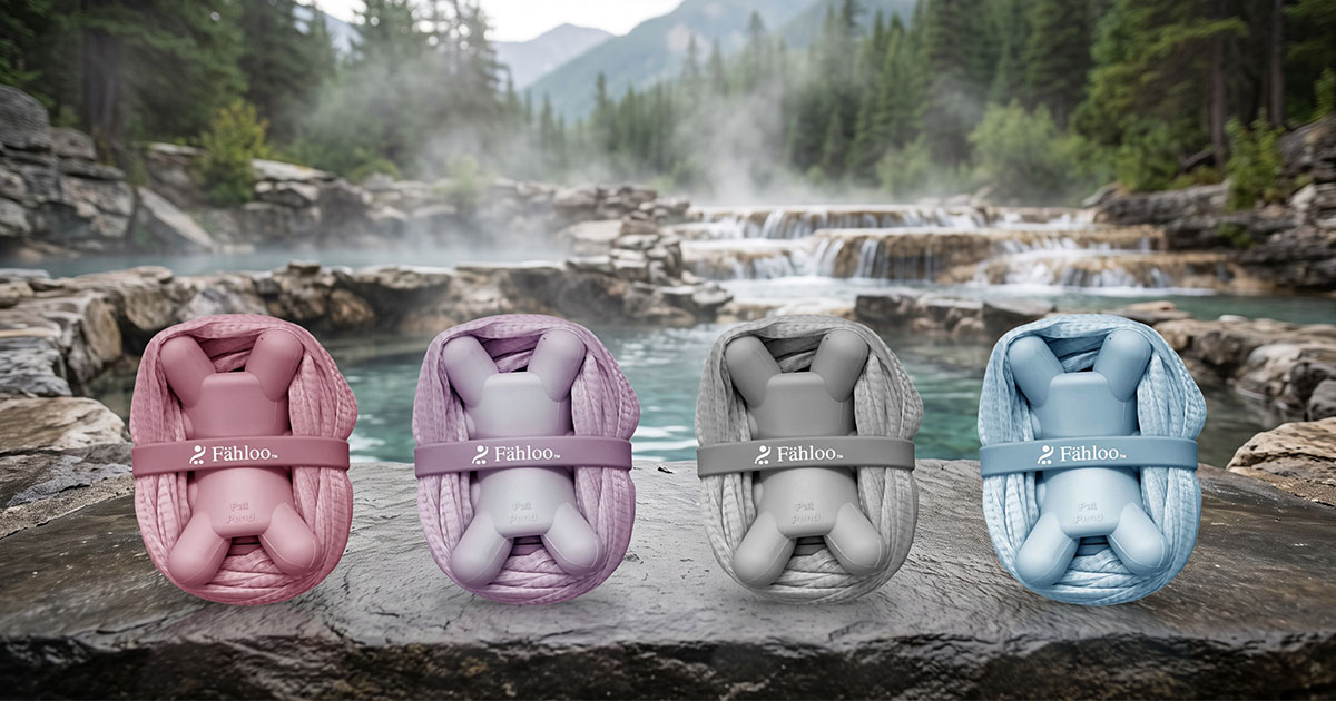 All four Fähloo colorways, left to right: Desert Rose, French Lilac, Pebble Grey and Sea Salt Blue, on natural stone by a mountain hot springs pool